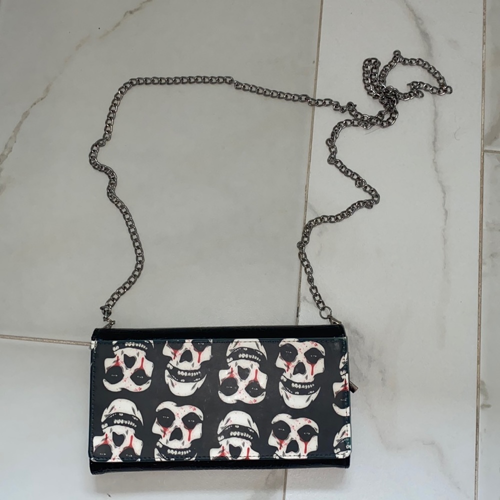 Purse with skulls on it, silver chain, croc leather on the back